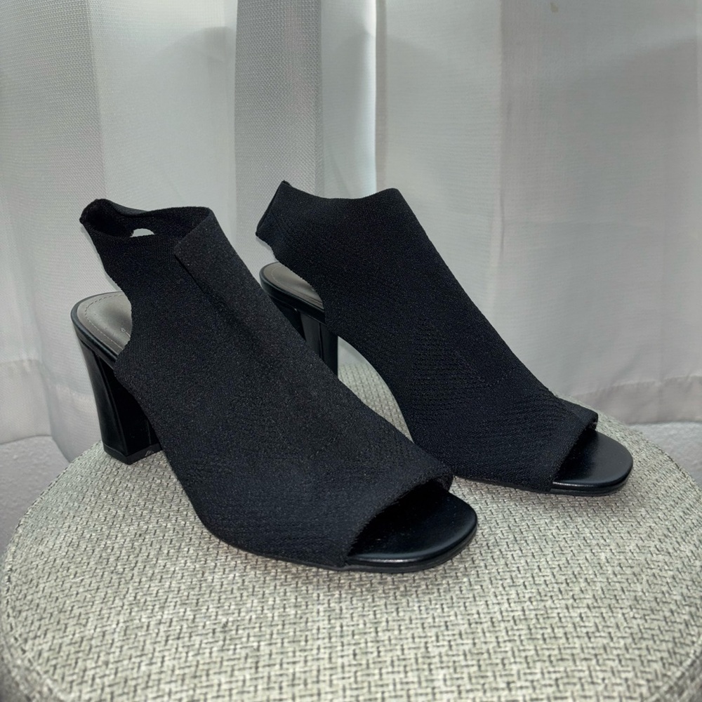 A black chunky heel with an open toe.